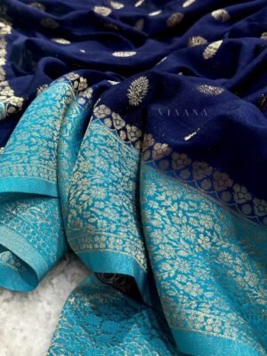 Georgette banarasi saree in navy blue color and contrast skyblue blouse
