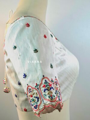 Multicolor thread embroidery with unique neckline and cutworked sleeves
