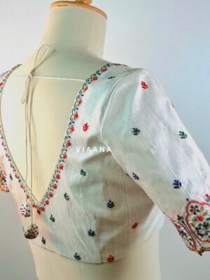 Multicolor thread embroidery with unique neckline and cutworked sleeves