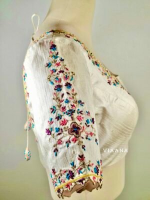 Multicolor thread and zari embroided with allover cutwork white blouse